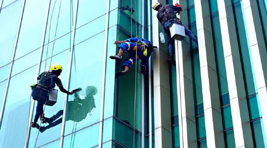 Facade cleaners working on a high-rise building